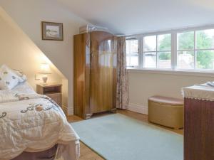 a bedroom with a bed and a window at The Wee Hoose in Kinghorn
