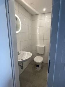 a small bathroom with a toilet and a sink at Altstadt Apartment, 15 zur Messe in Düsseldorf
