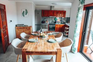 a dining room with a wooden table and chairs at Casa Riamar in São Jacinto