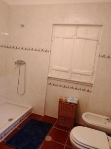 a bathroom with a toilet and a sink and a tub at CASA DA ALDEIA - Ponte de Sor (Alentejo) in Ponte de Sor