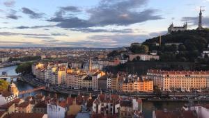 a view of a city with a river and buildings at L Ancien Canut Cosy in Lyon
