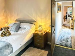 a teddy bear sitting on a bed in a bedroom at Portknockie Escape in Portknockie