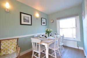 a dining room with a table and chairs at 6 Coastguard Cottages, Aldeburgh in Aldeburgh