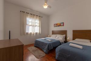 Ένα ή περισσότερα κρεβάτια σε δωμάτιο στο Casa no Tatuapé São Paulo - SP