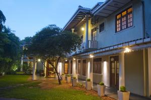 a house with lights on the side of it at Hotel Sunflower in Kataragama