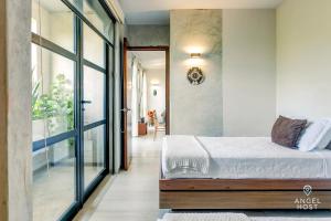 a bedroom with a bed and a sliding glass door at Chic Suites in the Heart of Tulum by Stella Rentals in Tulum +70 photos