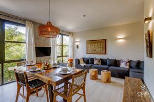 a living room with a table and a couch at Chic Suites in the Heart of Tulum by Stella Rentals in Tulum