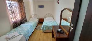 Postel nebo postele na pokoji v ubytování Hotel Liza