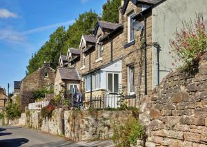 a row of stone houses in a street at Finest Retreats - Peak View in Two Dales
