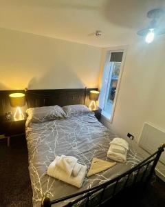 a bedroom with a bed with towels on it at The Mail Barn in Lamlash