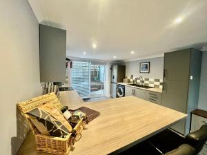 a kitchen with a wooden table in a room at The Mail Barn in Lamlash