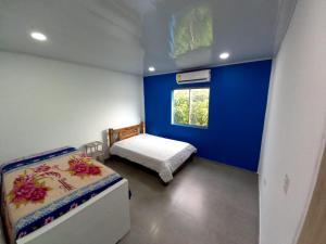 una piccola camera da letto con un letto e una finestra di APARTAMENTOS AMOBLADOS a Santa Marta Altre 23 foto