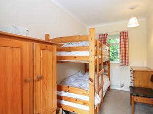 a bedroom with bunk beds and a desk at Byre Cottage 4 in Pulborough +32 photos