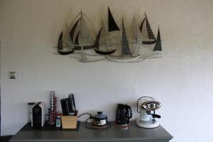 a shelf with several model boats hanging on a wall at Panorama Apartmanház in Badacsonytomaj