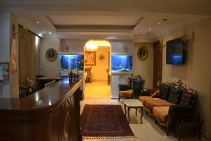 a living room with a bar and a fish tank at Blue Istanbul Hotel in Istanbul