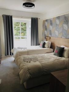 a bedroom with two beds and a window at Vincent House London Residence in London