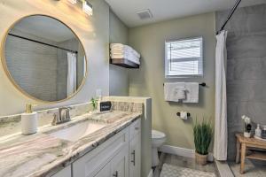 a bathroom with a sink and a mirror and a toilet at Cozy Sarasota Retreat - 3 Blocks to the Coast! in Sarasota +17 photos