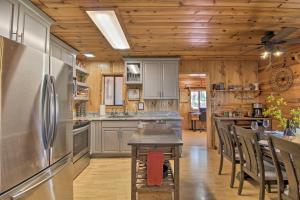 uma cozinha com um frigorífico em aço inoxidável e tectos em madeira em Pet-Friendly Show Low Retreat with Deck and Grill em Show Low