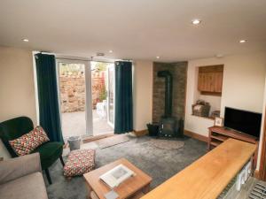 a living room with a couch and a tv at Crumble's Hideaway in York