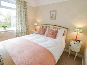 a bedroom with a bed and a window at Dolphin Court in Colwyn Bay