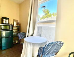 een tafel en 2 stoelen in een kamer met een raam bij Sweet Tuscan dreams in LA.Private entrance w/patio in Encino