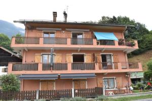 a large building with balconies and a fence at Les Clarines in Passy