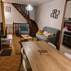 a living room with a table and a couch at SAINT DENIS PARIS STADE de FRANCE DISNEY in Saint-Denis