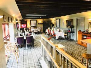 a dining room with tables and chairs in a restaurant at The Hidden Gem in Galloway Forrest in Balminnoch