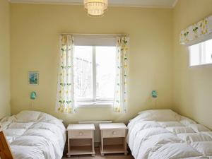 two twin beds in a room with a window at 8 person holiday home in STRÖMSTAD in Strömstad