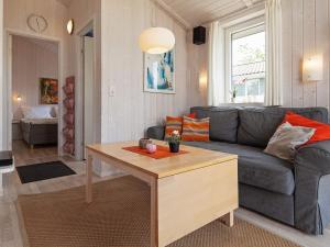 a living room with a couch and a table at 4 person holiday home in GROEMITZ in Grömitz