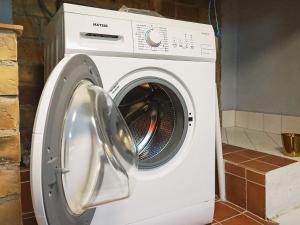 a white washing machine sitting in a kitchen at Peaceful stay near Orust Forest in Svanesund