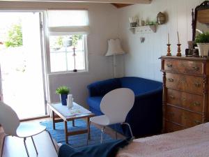 a bedroom with a blue couch and a table at Holiday home in Rönnäng 1 in Rönnäng