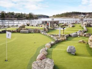 a golf course with rocks and a green at 5 person holiday home in str mstad in Strömstad