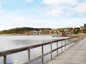 a wooden pier next to a body of water at 5 person holiday home in str mstad in Strömstad