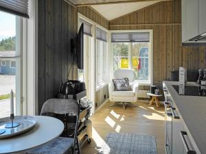 a kitchen with a table and a chair in a room at 5 person holiday home in K LLEK RR in Spjärr