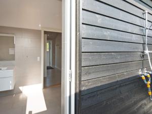 a sliding barn door in a bathroom with a kitchen at 12 person holiday home in R m in Rømø Kirkeby