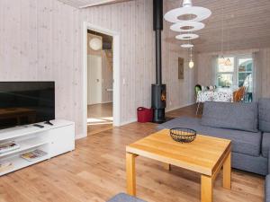 a living room with a couch and a table at 12 person holiday home in R m in Rømø Kirkeby