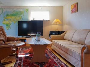 a living room with a couch and a table at Holiday home OSKARSHAMN II in Oskarshamn