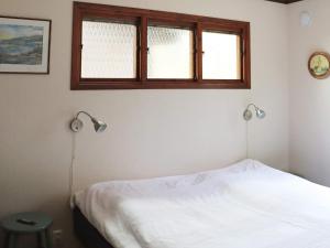 a bedroom with two lamps and a bed in it at 6 person holiday home in KNÄRED in Knäred
