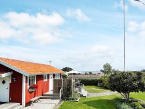 a red house with an orange roof at 4 person holiday home in ONSALA in Onsala