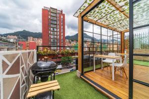 a balcony with a table and a view of a city at Anima 57 in Bogotá