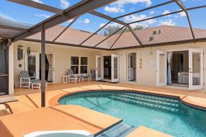 a swimming pool on a patio with a house at Single Family no Stairs 4BR Kissimmee OI2800 in Orlando