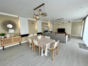 a living room with a table and chairs and a couch at Tush villa is a new, spacious, modern, cheerful in Calodyne