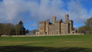 an old castle sitting on top of a lush green field at 10 Berisay Place in Stornoway