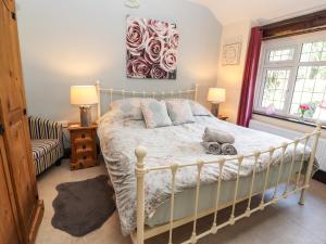 a bedroom with a bed and a painting on the wall at Ty Cerrig in Rhyl