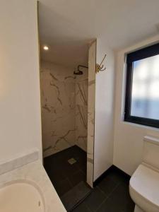 a bathroom with a shower and a toilet at London Sky Home - stunning 3 bed apt in the Sky in London