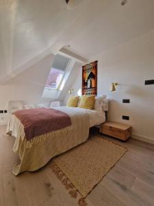 a bedroom with a large bed and a window at London Sky Home - stunning 3 bed apt in the Sky in London