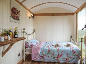 a bedroom with a bed with two stuffed animals on it at The Cider Pressers Hut-uk39773 in Trefeglwys