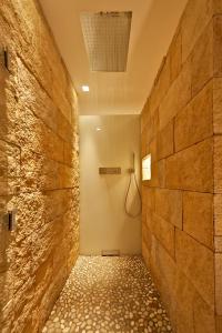 a bathroom with a walk in shower in a wall at Designer-Loft mit Whirlpool in Cologne