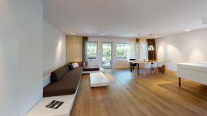 a living room with a couch and a table at Designer-Loft mit Whirlpool in Cologne